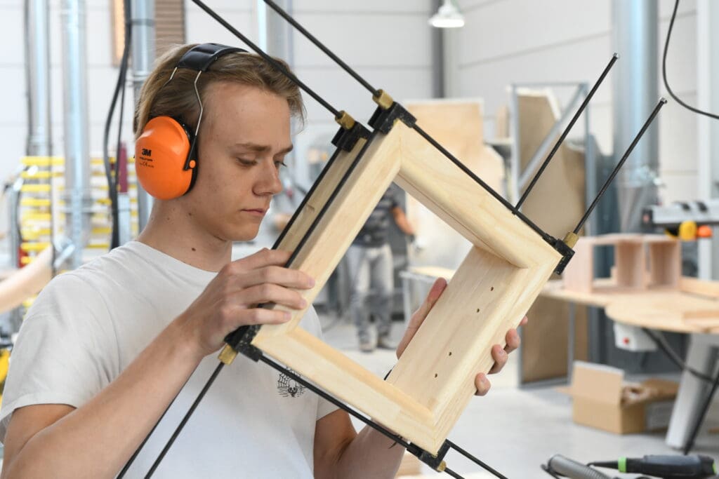 Young eyes inspect the small quality details during production of pet doors - Tomsgates manufacturing Belgium